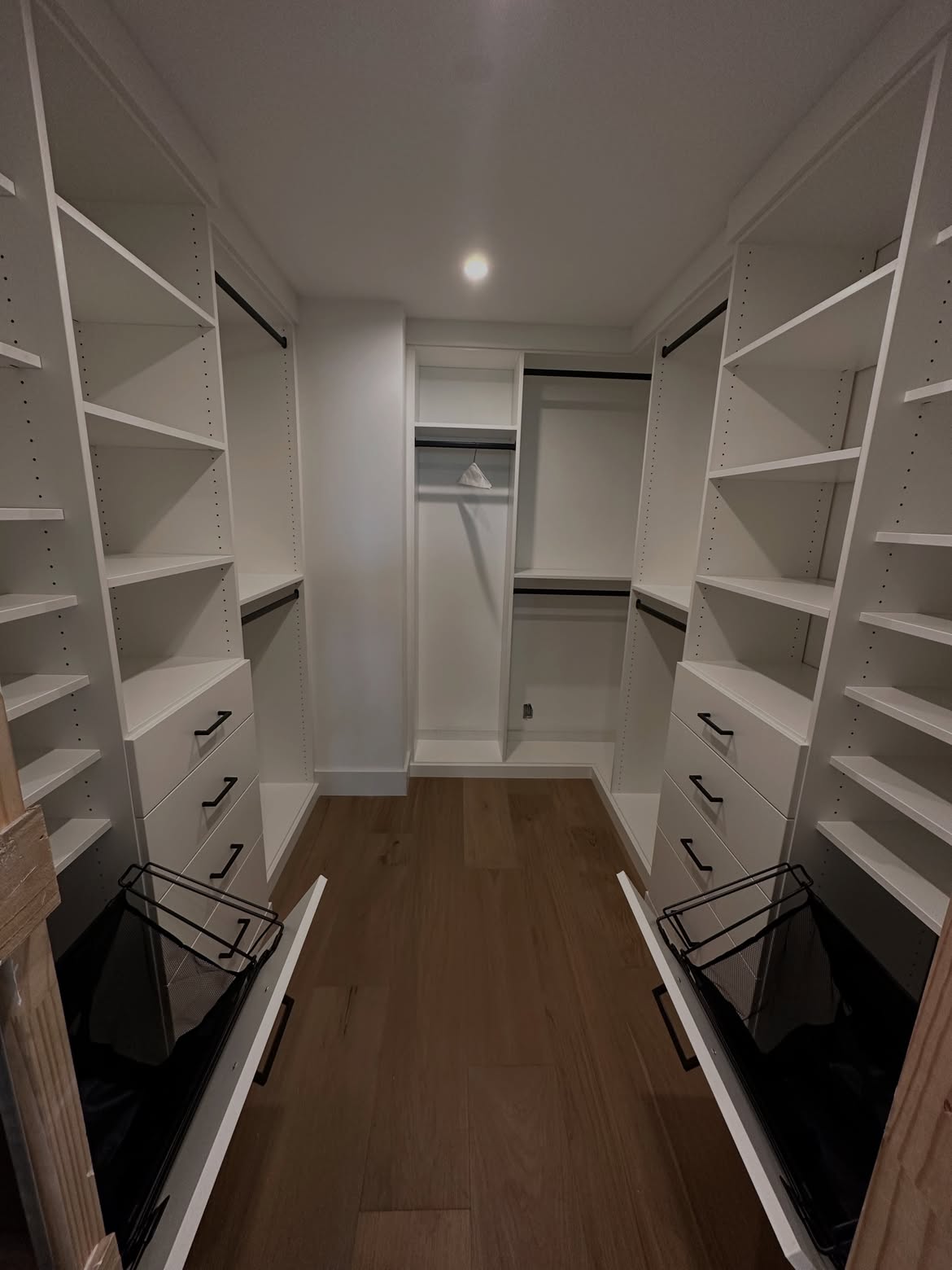 White walk-in closet with drawer towers