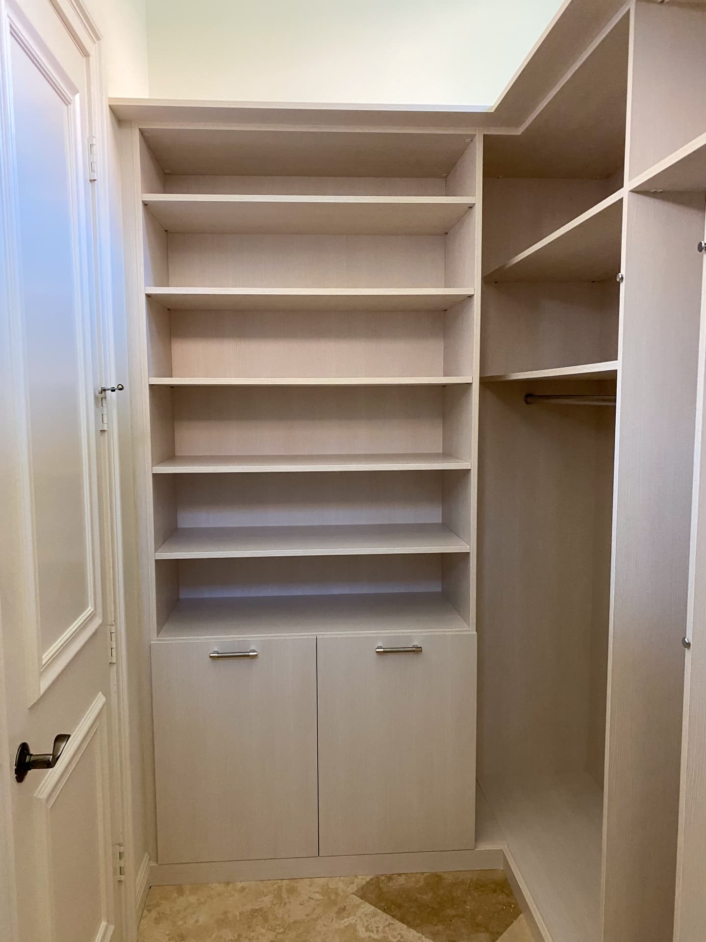 White closet with shelving tower and lower cabinets