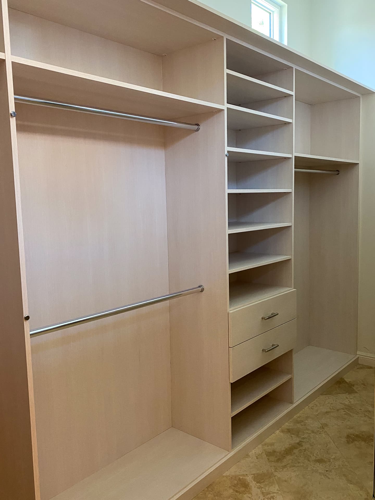 White walk-in closet with double hanging rods