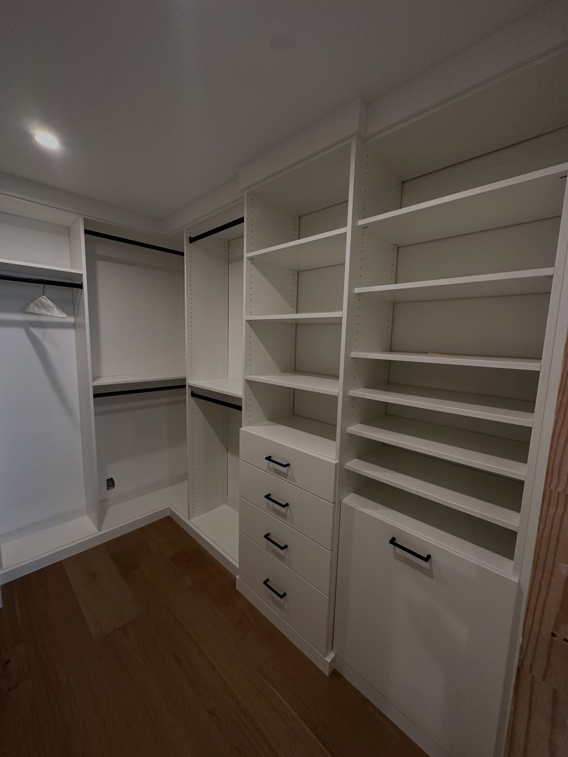 White corner closet with hampers