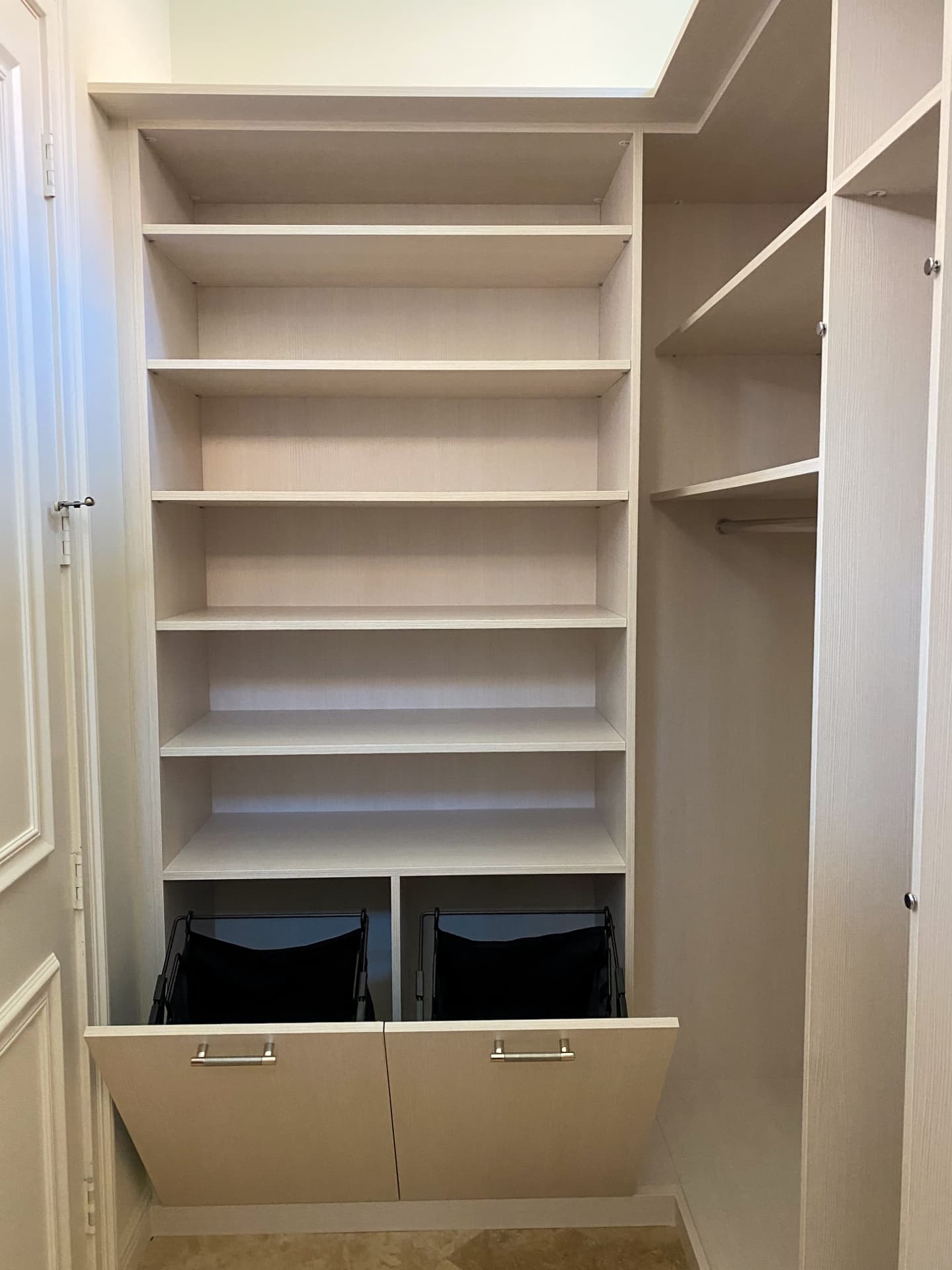 White closet with tilt-out hampers and shelves
